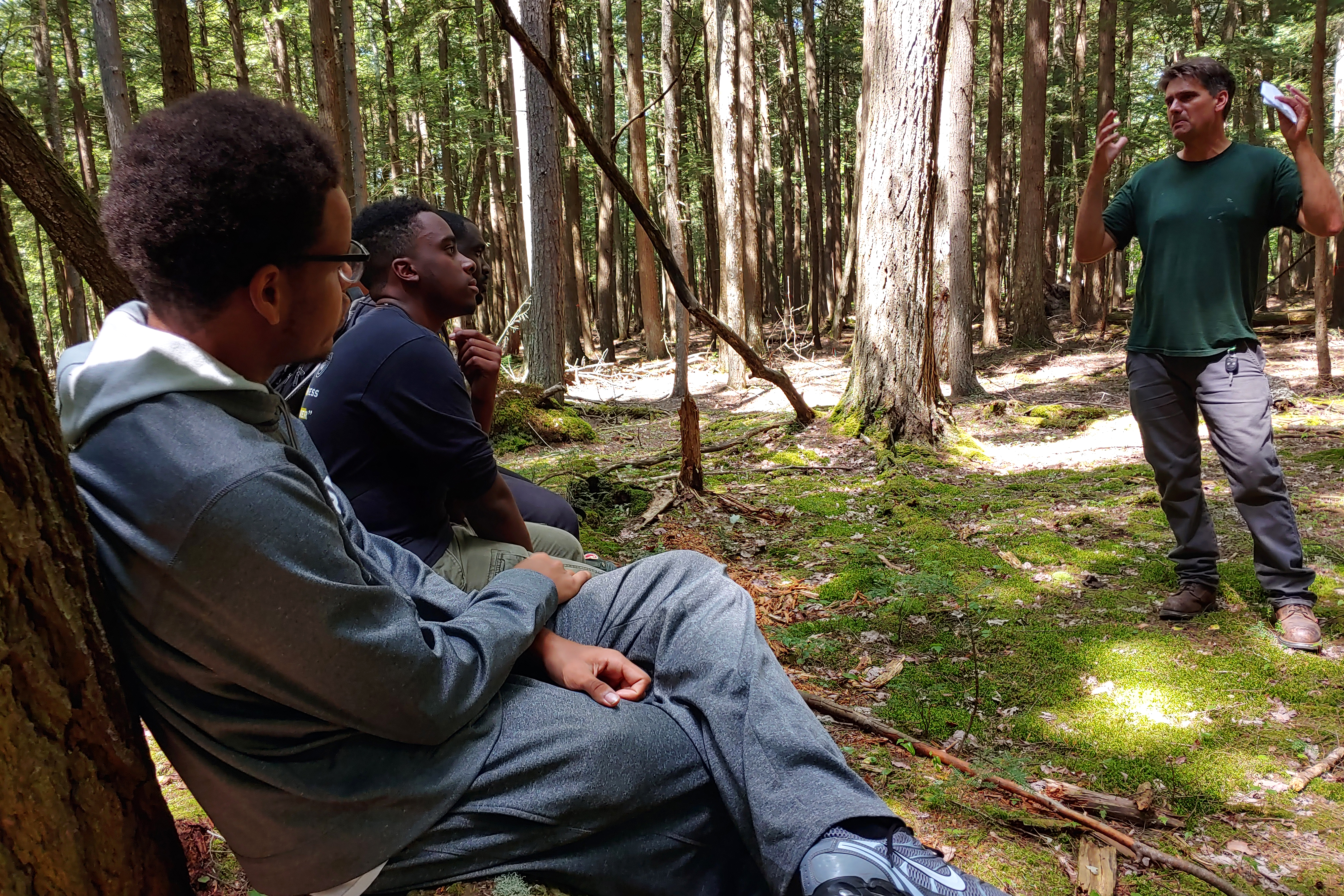 Students receiving field instruction in a forest